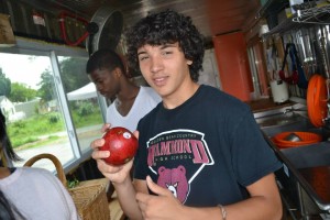 Woodoo holds up a pomegranate